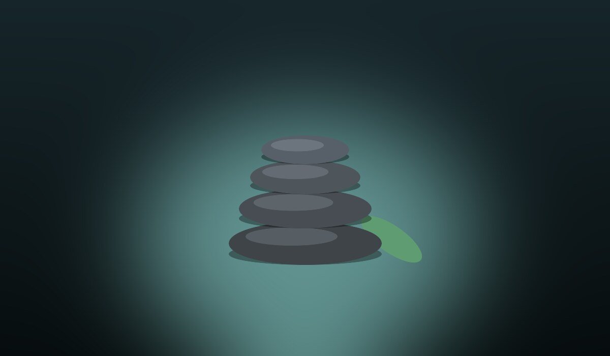 Stacked massage stones representing a calming nuru massage session in Manhattan